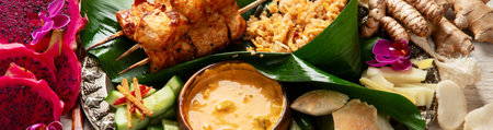 A traditional Indonesian chicken satay, served with steamed rice and sauce on a light background. Top view. Panorama, banner.の写真素材