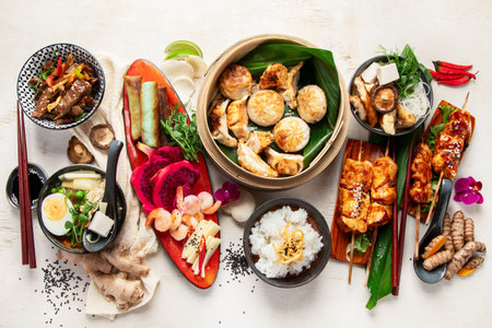 Assortment of traditional Asian food dishes on a light backgrount. Top view.の写真素材