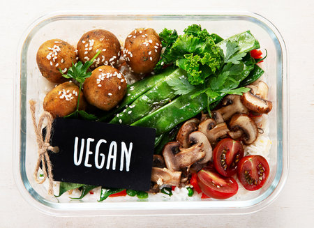 Colorful meal prep containers filled with healthy vegan meal. top view, flat lay, copy spaceの写真素材