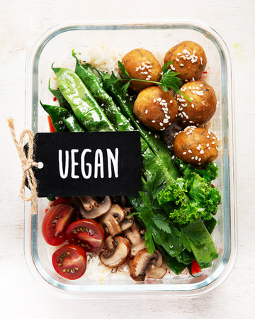 Colorful meal prep containers filled with healthy vegan meal. top view, flat lay, copy spaceの写真素材