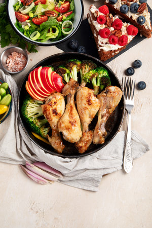 Variety of plates and bowls with green vegetables, chicken and fresh salads on a light background. Healthy food concept. Top view. Copy space.の写真素材
