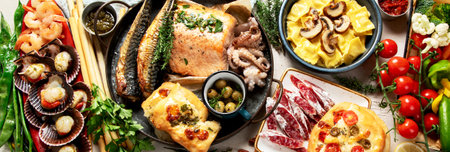 Assortment various Mediterranean food - fish, shrimp, seafood, ravioli, vegetables on a white background. Top view. Panorama, banner.の写真素材