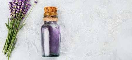Bottle of essential oil and lavender flowers on light gray background. top view, flat lay, copy spaceの写真素材