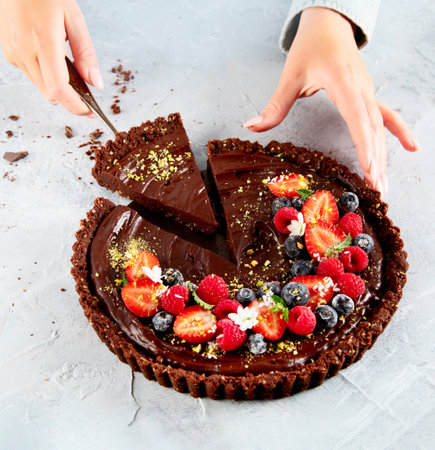 Young woman holding homemade chocolate tartの写真素材