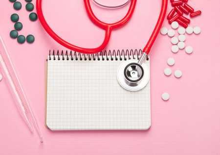 Various medical equipment, pipette, drugs, tablets, capsules, spray on pink background. Top view.の写真素材