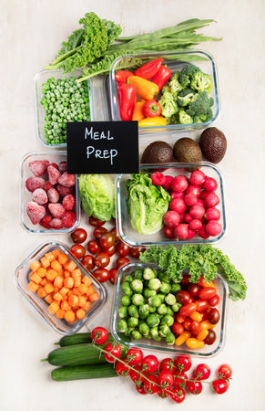 Glass containers with different fresh products such vegetables and fruits on a light background. Top view.の写真素材