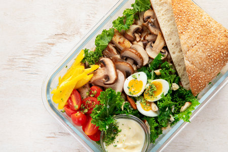 Healthy meal prep containers with chicken and vegetables on light background. Top view. Lunch box. Copy space.の写真素材