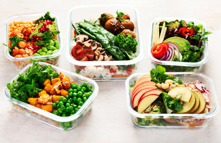 Preparing healthy meals for vegans. Food and snacks in containers on a light background. Top view.の写真素材
