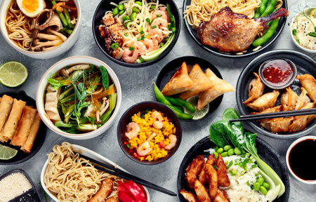 Assorted Asian dishes and snacks on dark gray background.の写真素材