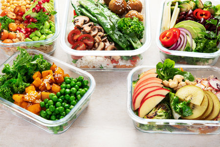Preparing healthy meals for vegans. Food and snacks in containers on a light background. Top view.の写真素材