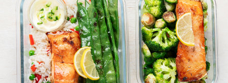 Salmon with rice and vegetables in a glass containers made for meal prep on a light background, top view. Healthy lifestyle. Panorama.の写真素材