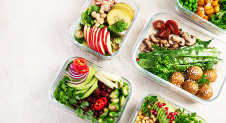 Preparing healthy meals for vegans. Food and snacks in containers on a light background. Top view. Copy space.の写真素材