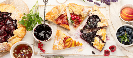Homemade summer pies or galettes on white wooden table. Top view, flat layの写真素材