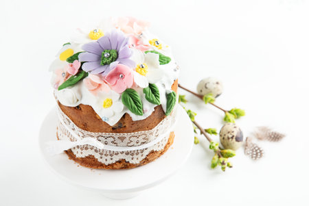 Easter cake, sweet bread decorated with bunny ears and spring flowers on a pink background. Top...