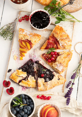 Homemade summer pies or galettes on white wooden table. Top view, flat layの写真素材
