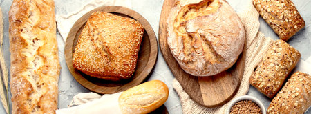 Various types of fresh baked bread on light gray background. Top view, flat lay, copy spaceの写真素材