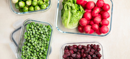 Glass containers with different fresh products such vegetables and fruits on a light background. Top view. Panorama.の写真素材