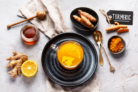 Healthy turmeric golden tea on light gray background. Indian traditional drink. Top view, flat layの写真素材