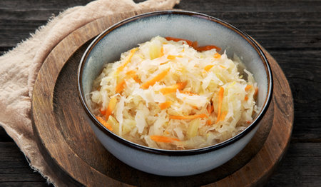 Sauerkraut on wooden background. Salting vegetables. German traditional food concept.の写真素材
