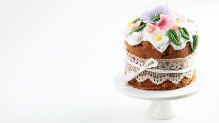 Easter cake, sweet bread decorated with bunny ears and spring flowers on a pink background. Top view. Copy space.の写真素材