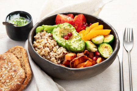 Budha bowl with quinoa, avocado, tomatoes, chickpeas and broccoli. Vegan Budha bowl on light background, top view.の写真素材