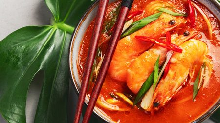 Red curry with chicken in bowl on light gray background. Traditional Asian food. Top view, flat lay, copy spaceの写真素材