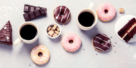 Donuts with coffee on gray background, top viewの写真素材