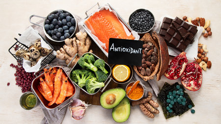 Assortment of various foods for clean eating antioxidant detox diet on a light background. Fruits, vegetables, seeds, powder, spinach, ginger, berries. Top view.の写真素材