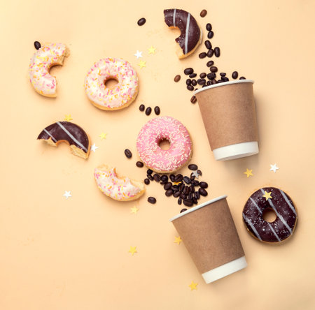 Donuts with coffee on yellow background.の写真素材