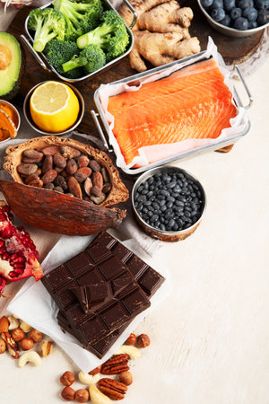 Assortment of various foods for clean eating antioxidant detox diet on a light background. Fruits, vegetables, seeds, powder, spinach, ginger, berries. Top view.の写真素材