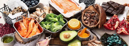Assortment of various foods for clean eating antioxidant detox diet on a light background. Fruits, vegetables, seeds, powder, spinach, ginger, berries. Top view. Panorama.の写真素材