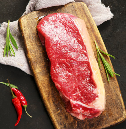 Raw striploin beef steak. Freshly grilled. Healthy dinner. Top view, flat lay, copy spaceの写真素材