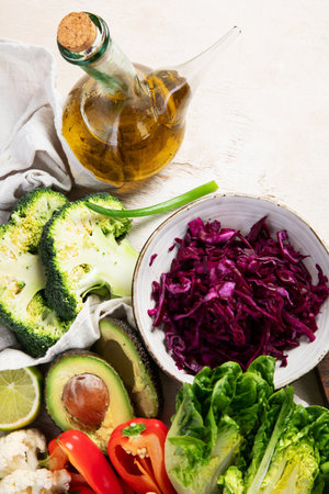 Ingredients for vegetable salad. Delicious healthy food. Vegan concept. On a light background, top view.の写真素材