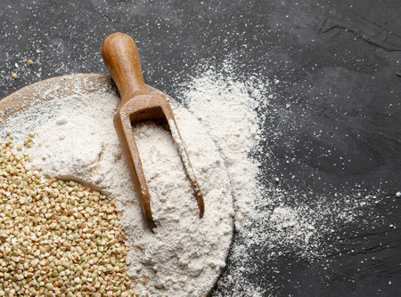 Raw green buckwheat on dark background. Food ingredients. Concept of organic food. Top view. Copy space.の写真素材