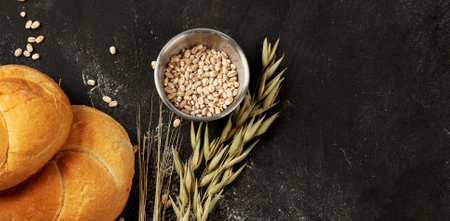 Bread on dark background. Fresh homemade pastry. Top view. Panorama with copy space.
