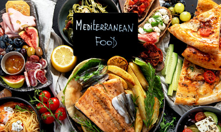 Assortment of various Mediterranean food - fish, seafood, sauces, pasta, snacks, pizza on a black background. Top view.の写真素材