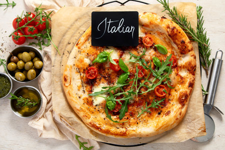 Hot homemade pizza Margherita on a light background Cheese in a pizza crust. Tasty vegetable pizza. Top view.の写真素材