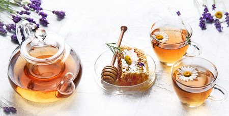Healthy herbal tea with Lavender and chamomile flowers with honey on a white background. Top view. Panorama.の写真素材