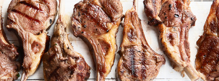 Grilled lamb ribs. Rack of lamb chop on white wooden background. Top view. Panorama.の写真素材