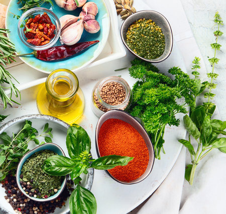 Fresh and dried herbs and spices on a white background. Cooking, healthy eating concept. Top view.の写真素材