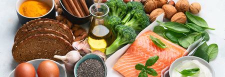 Cholesterol diet, food high in antioxidants, vitamins and minerals on a gray background. Top view. Panorama.の写真素材