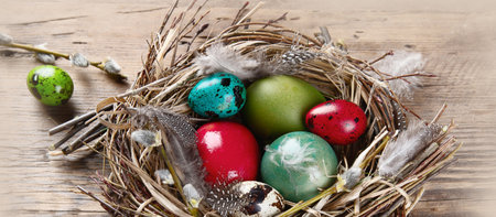 Easter eggs in nest on a wooden background. Happy Easter. Top view.の写真素材