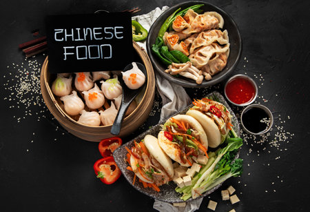 Chinese dumplings, soy sauce, dim sum on a dark background. Traditional Asian food concept. Top viewの写真素材