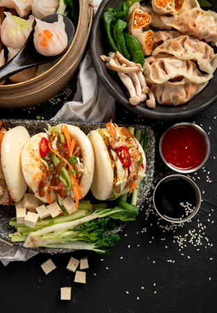 Chinese dumplings, soy sauce, dim sum on a dark background. Traditional Asian food concept. Top view. Copy space.の写真素材