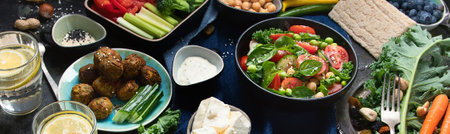 Vegetarian variety dishes on a black background. Healthy vegan food. Clean food and eating concept. Top view. Panorama.の写真素材