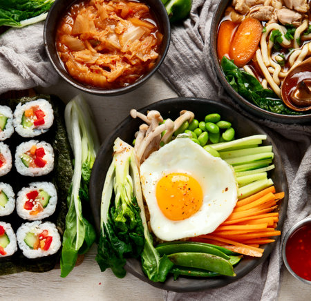 Korean traditional food. Bibimbap, traditional Korean dish, rice, vegetables, Kimchi on a white background. Top view. Copy space.の写真素材
