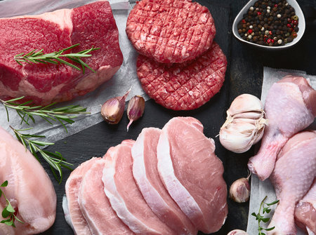 Fresh different meat types on a black background. Top view.の写真素材