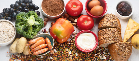 Natural sources of chromium. Natural products healthy containing chromium: egg, tomato, cocoa, grape, bread, bean, shrimp, potato, yogurt. Top view. Panorama.の写真素材