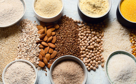 Various gluten free flour - chickpeas, rice, buckwheat, quinoa, almond, corn, oatmeal on gray background. Top view.の写真素材