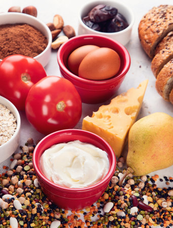 Natural sources of chromium. Natural products healthy containing chromium: egg, tomato, cocoa, grape, bread, bean, shrimp, potato, yogurt. Top view. Panorama.の写真素材